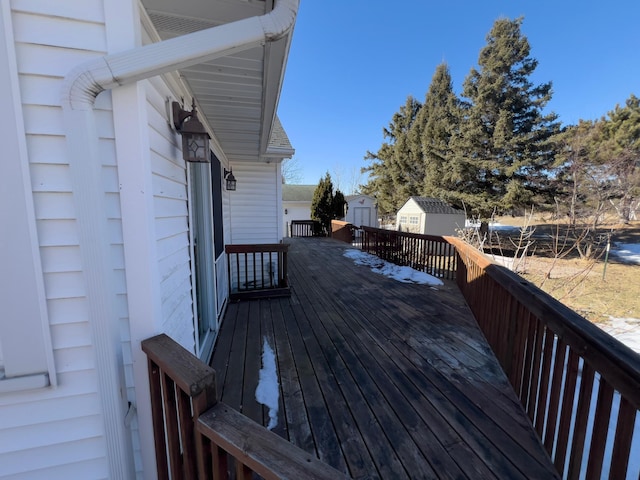 wooden terrace featuring an outbuilding