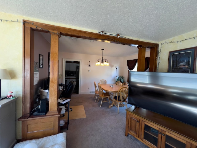 carpeted dining area featuring visible vents, a notable chandelier, and a textured ceiling