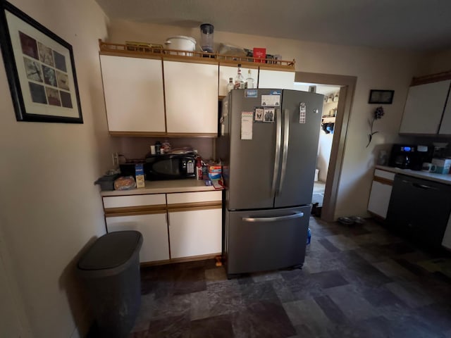 kitchen with black appliances, white cabinets, and light countertops