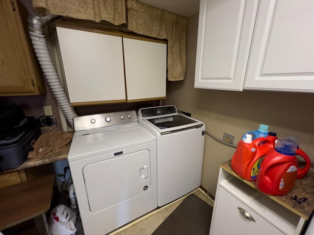 washroom featuring cabinet space and washer and dryer