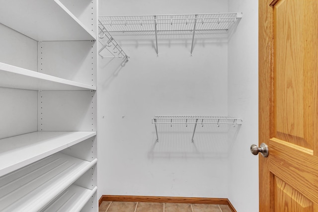 walk in closet featuring tile patterned flooring