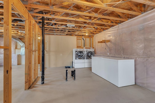 below grade area featuring refrigerator and separate washer and dryer