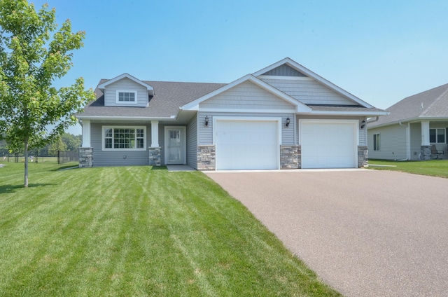 324 Bluebird Dr NW, Isanti, MN 55040 - craftsman house featuring a garage, stone siding, driveway, and roof with shingles