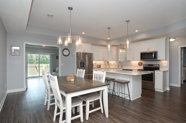 324 Bluebird Dr NW, Isanti, MN 55040 - dining room featuring dark wood-type flooring and recessed lighting