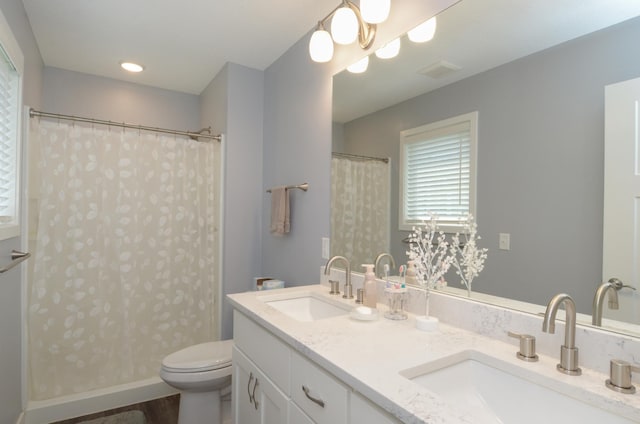 324 Bluebird Dr NW, Isanti, MN 55040 - bathroom with double vanity, a shower with curtain, and wood finished floors