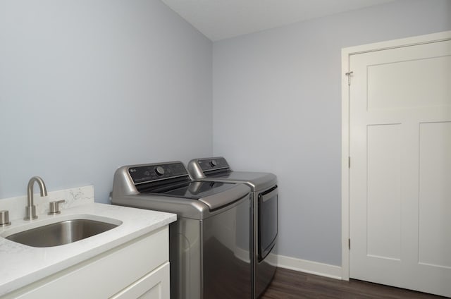 324 Bluebird Dr NW, Isanti, MN 55040 - washroom featuring independent washer and dryer, dark wood-style flooring, and cabinet space
