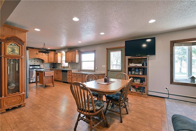 dining room with baseboard heating, light wood-type flooring, and recessed lighting