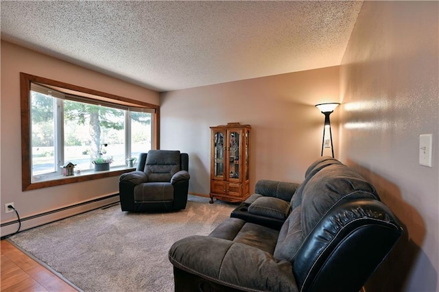 living room with a baseboard heating unit, a textured ceiling, and carpet flooring