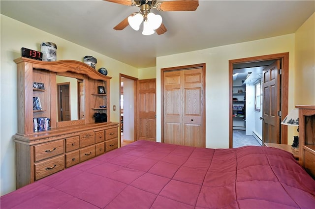 bedroom featuring a baseboard heating unit, a closet, and ceiling fan