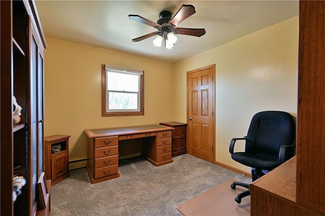 carpeted office space featuring ceiling fan, baseboards, and baseboard heating