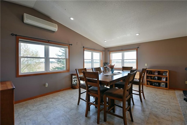 dining area featuring a wall unit AC, vaulted ceiling, a textured ceiling, and baseboards