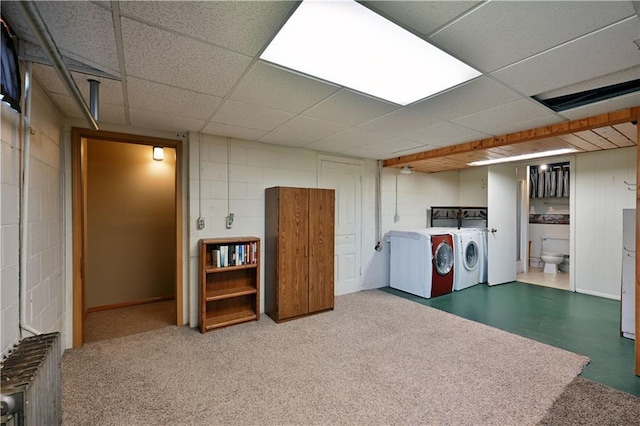 washroom with laundry area, washer and clothes dryer, concrete block wall, and radiator