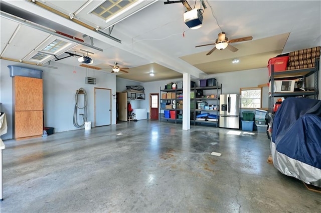 garage with stainless steel refrigerator with ice dispenser and a garage door opener