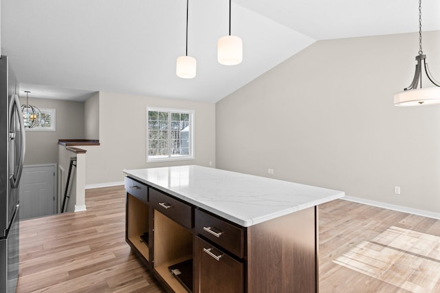 kitchen featuring light wood-type flooring, dark brown cabinetry, stainless steel refrigerator with ice dispenser, and lofted ceiling