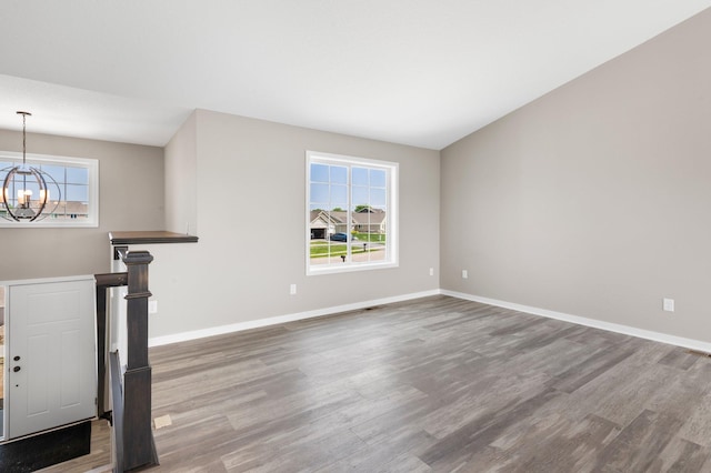 1003 Misty Meadow Blvd, Buffalo, MN 55313 - spare room with a chandelier, wood finished floors, and baseboards
