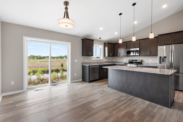 1003 Misty Meadow Blvd, Buffalo, MN 55313 - kitchen with stainless steel appliances, dark brown cabinets, light wood finished floors, baseboards, and vaulted ceiling