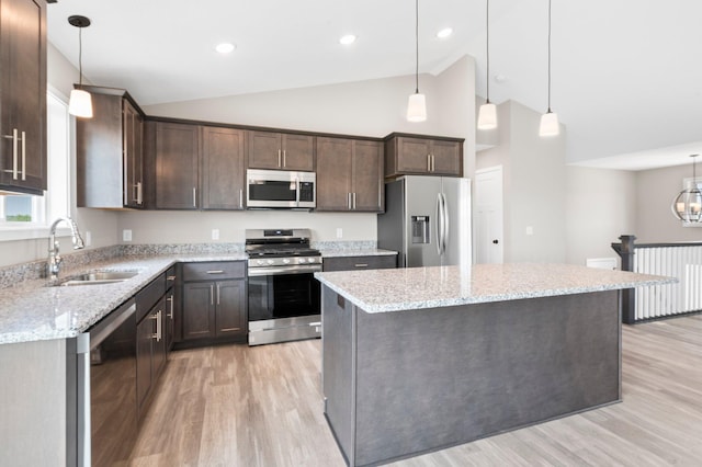 1003 Misty Meadow Blvd, Buffalo, MN 55313 - kitchen featuring stainless steel appliances, a sink, dark brown cabinets, light wood finished floors, and light stone countertops