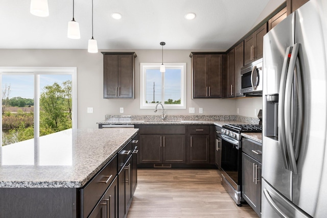 1003 Misty Meadow Blvd, Buffalo, MN 55313 - kitchen with appliances with stainless steel finishes, a sink, plenty of natural light, dark brown cabinetry, and recessed lighting