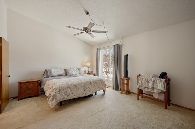 bedroom featuring light carpet, vaulted ceiling, a textured ceiling, ceiling fan, and baseboards