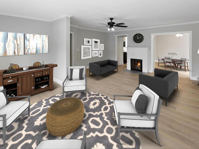 living room featuring ornamental molding, a brick fireplace, and light wood-style floors