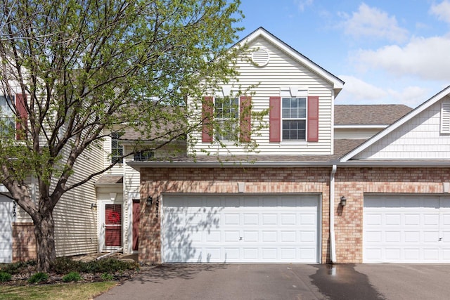 15374 Flower Way, Apple Valley, MN 55124 - view of front of home with brick siding, a shingled roof, and driveway