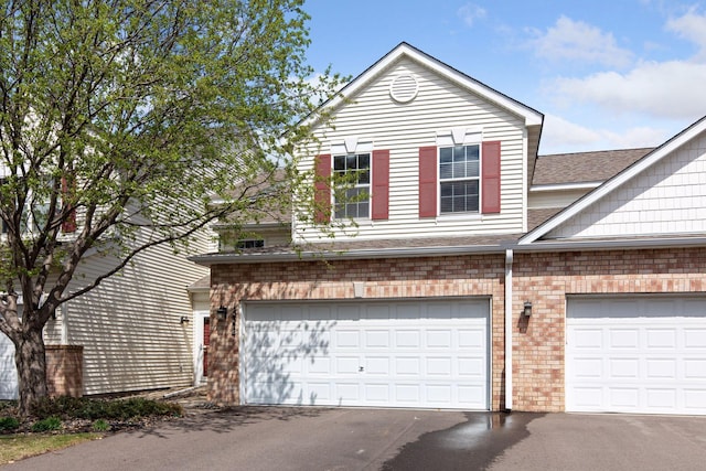 15374 Flower Way, Apple Valley, MN 55124 - view of home's exterior with driveway, a shingled roof, and brick siding