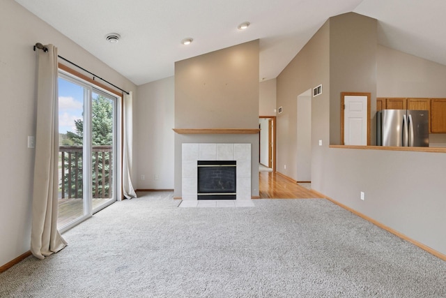 15374 Flower Way, Apple Valley, MN 55124 - unfurnished living room featuring baseboards, lofted ceiling, and carpet