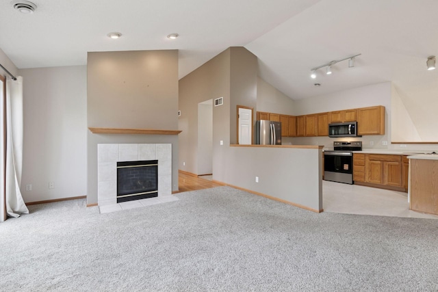 15374 Flower Way, Apple Valley, MN 55124 - kitchen with rail lighting, light colored carpet, open floor plan, and stainless steel appliances