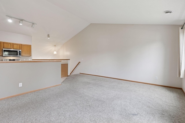 15374 Flower Way, Apple Valley, MN 55124 - unfurnished living room featuring lofted ceiling, light colored carpet, and baseboards