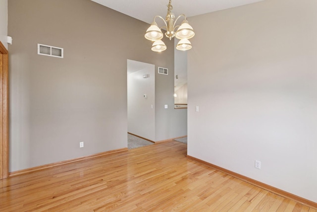 15374 Flower Way, Apple Valley, MN 55124 - spare room featuring baseboards, visible vents, wood finished floors, and an inviting chandelier
