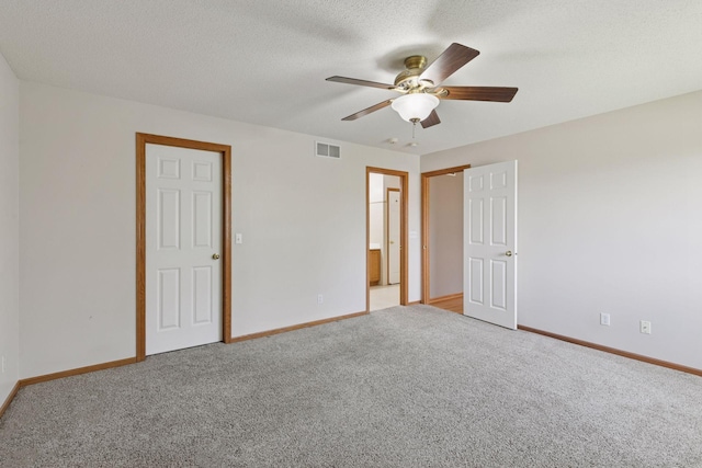 15374 Flower Way, Apple Valley, MN 55124 - unfurnished bedroom featuring carpet flooring, connected bathroom, a ceiling fan, visible vents, and baseboards