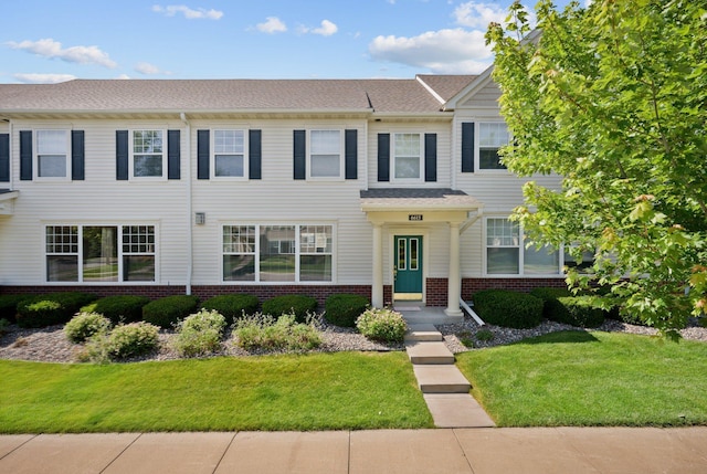 view of front of property with brick siding and a front yard