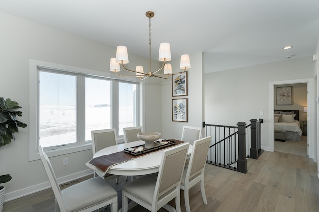 dining room with light wood finished floors, baseboards, a chandelier, and recessed lighting