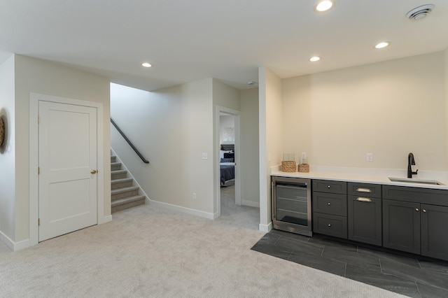 bar featuring wine cooler, stairway, a sink, and recessed lighting