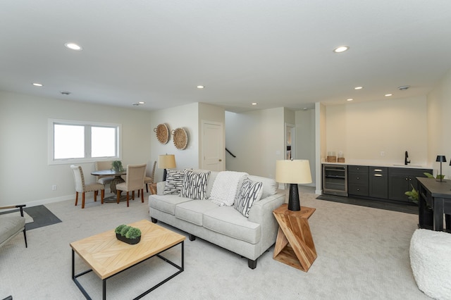 living area with wine cooler, recessed lighting, light carpet, wet bar, and baseboards