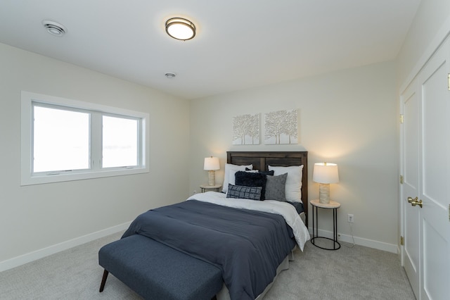 bedroom featuring baseboards and light colored carpet