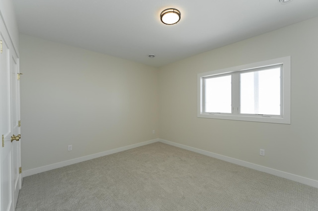 carpeted spare room with baseboards