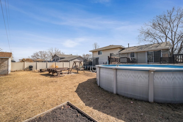 view of yard with a fenced in pool and fence