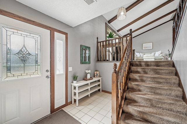 entrance foyer with visible vents, stairway, light tile patterned floors, baseboards, and vaulted ceiling with beams