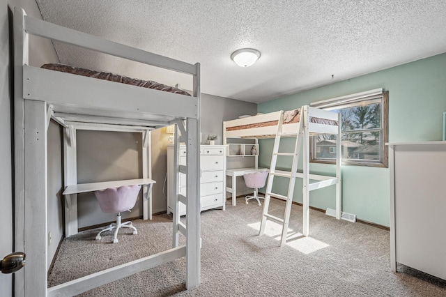 unfurnished bedroom featuring visible vents, carpet, baseboards, and a textured ceiling