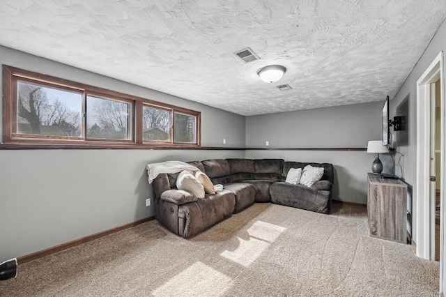 living room featuring visible vents, a textured ceiling, baseboards, and carpet floors