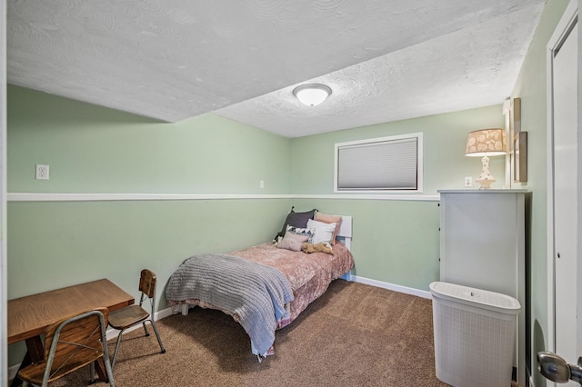 bedroom with a textured ceiling, baseboards, and carpet