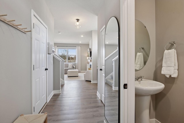 bathroom featuring wood finished floors and baseboards