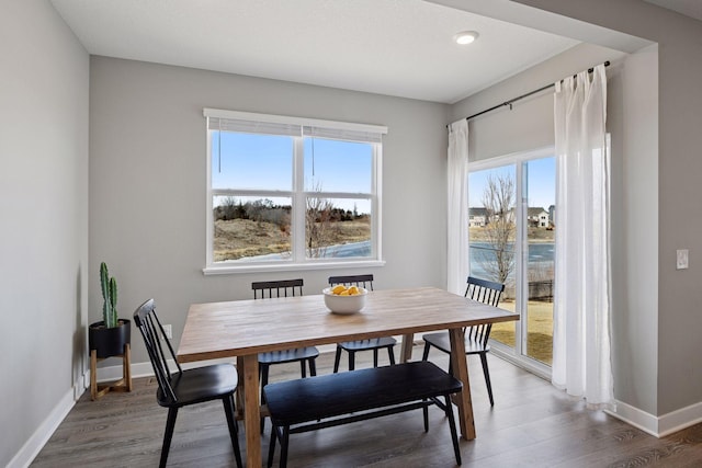 dining area featuring wood finished floors and baseboards