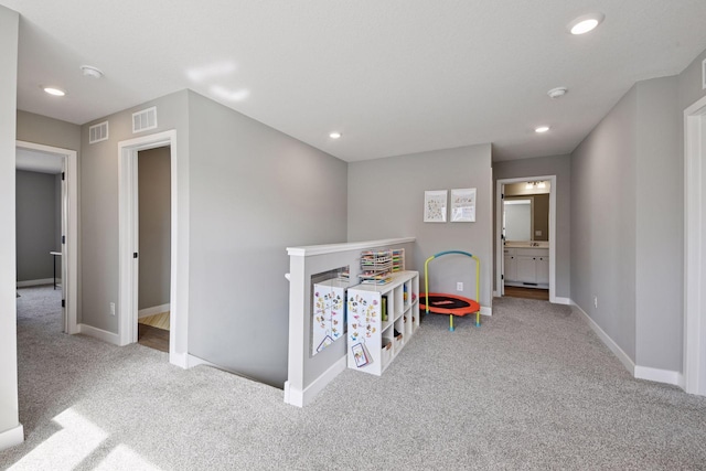 carpeted bedroom with visible vents, recessed lighting, ensuite bath, and baseboards