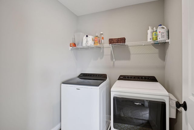 washroom featuring washing machine and dryer and laundry area