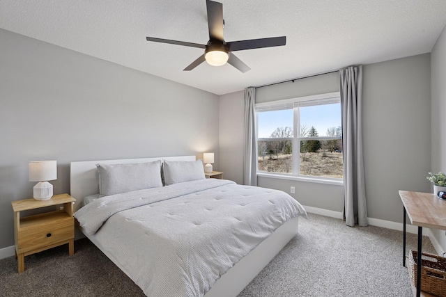 bedroom with a textured ceiling, a ceiling fan, baseboards, and light carpet