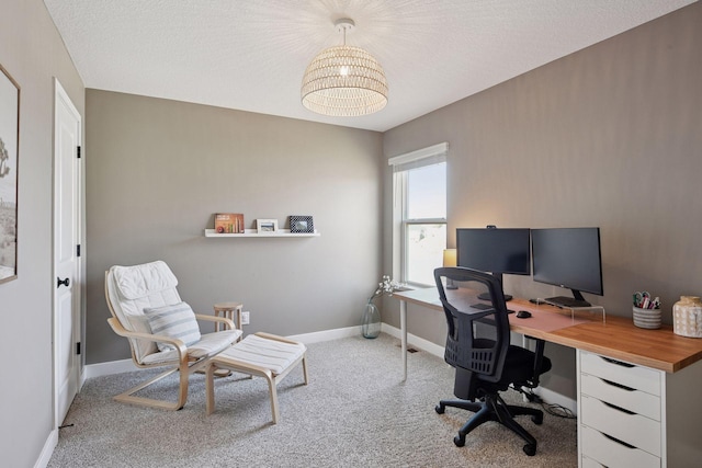 carpeted office space featuring baseboards and a textured ceiling