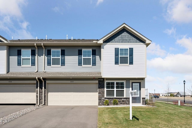 8730 Parkington Ave NE, Otsego, MN 55330 - view of property with aphalt driveway, a shingled roof, a front lawn, stone siding, and a garage