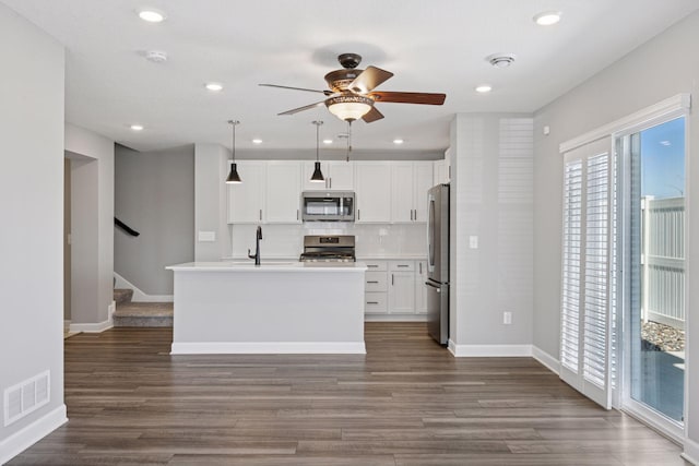 8730 Parkington Ave NE, Otsego, MN 55330 - kitchen with ceiling fan, visible vents, tasteful backsplash, appliances with stainless steel finishes, and dark wood-style flooring